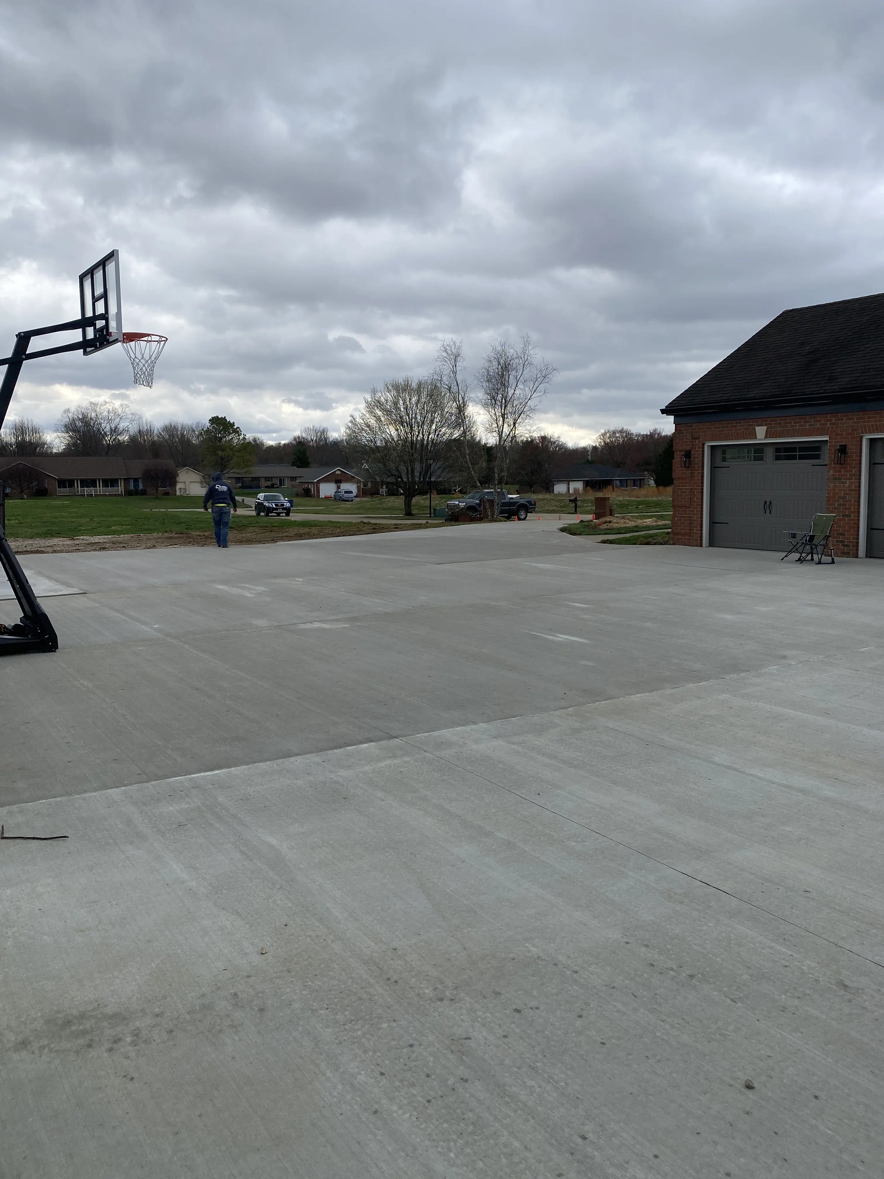 Large concrete driveway with basketball court
