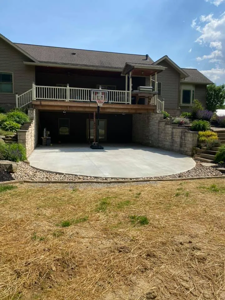 Large backyard patio with retaining walls