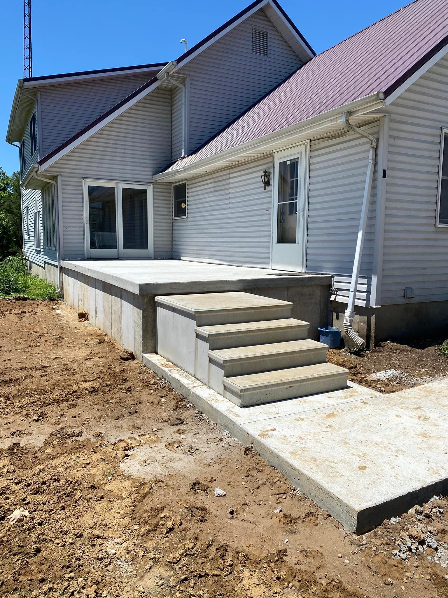 Concrete steps and raised patio